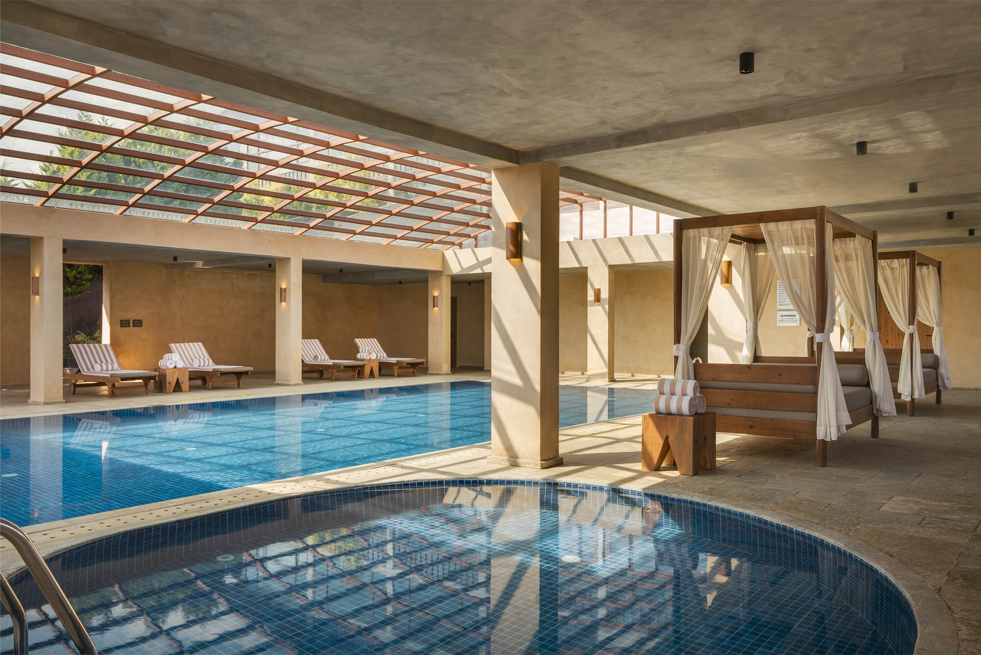 Garden-facing spa and pool area surrounded by greenery.